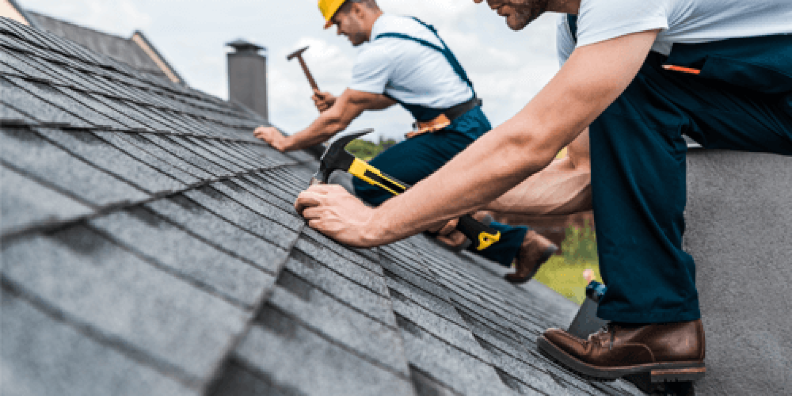 Man nailing shingles on a new roof